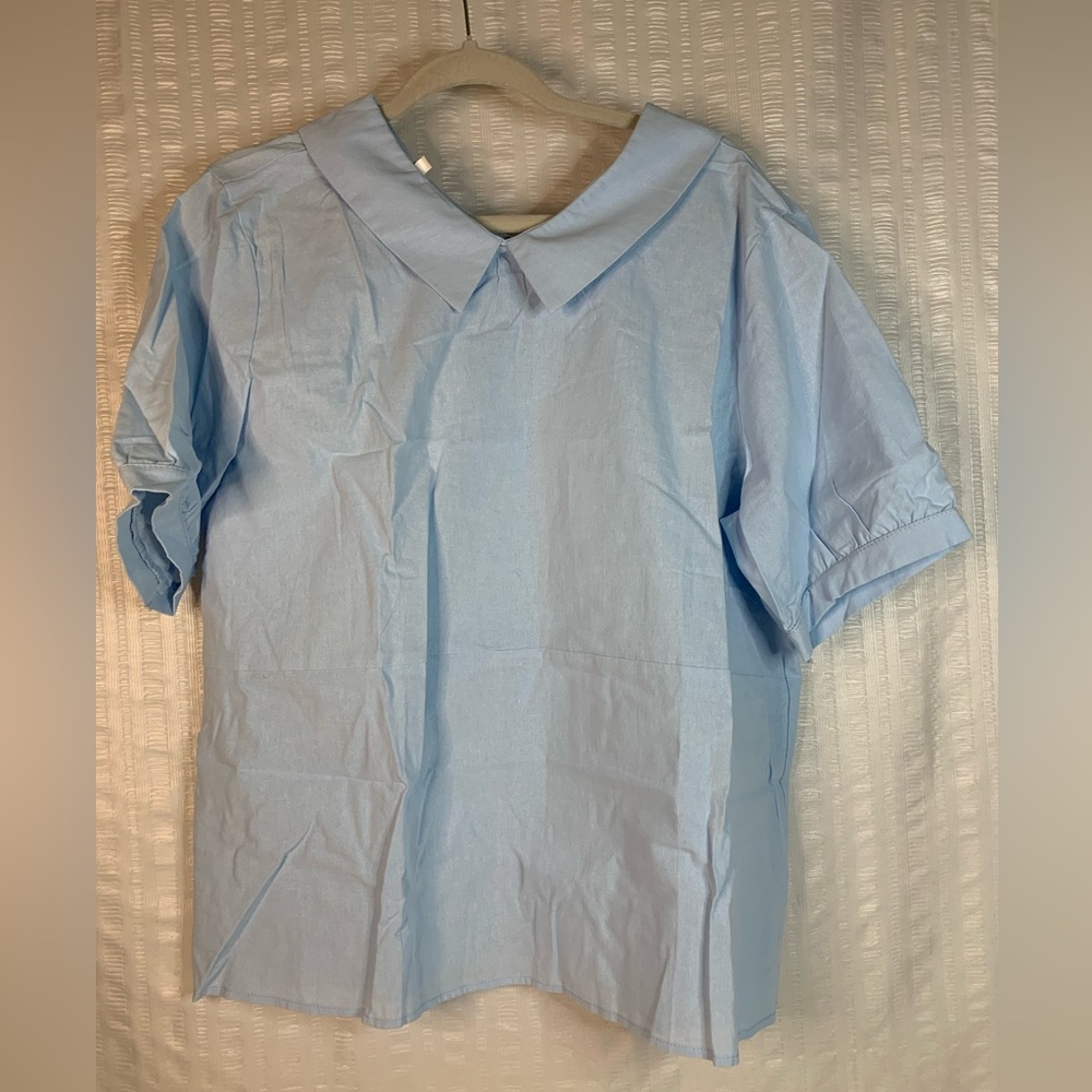 NWOT Women’s lightweight short sleeve blouse in light blue.